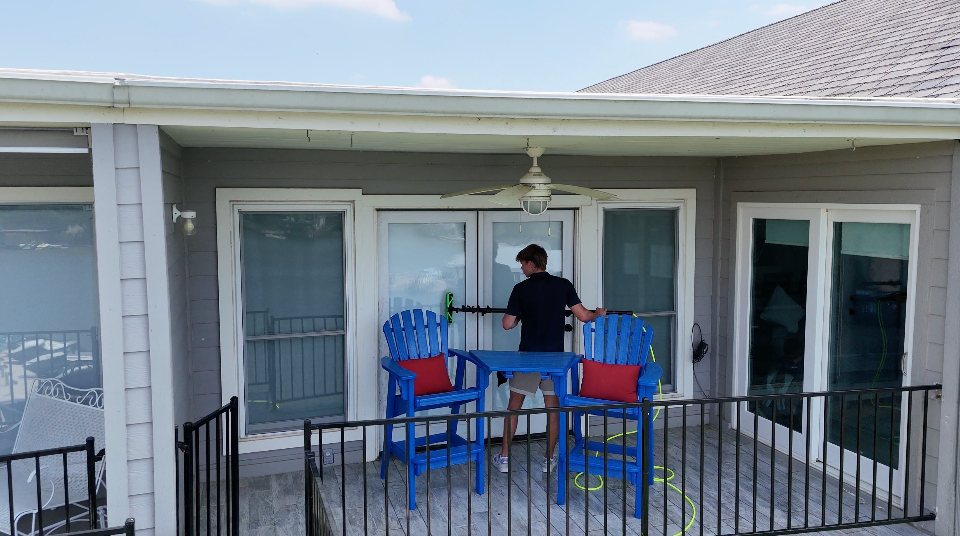 ClearCrew owner cleaning sliding glass doors on a Lake LBJ deck