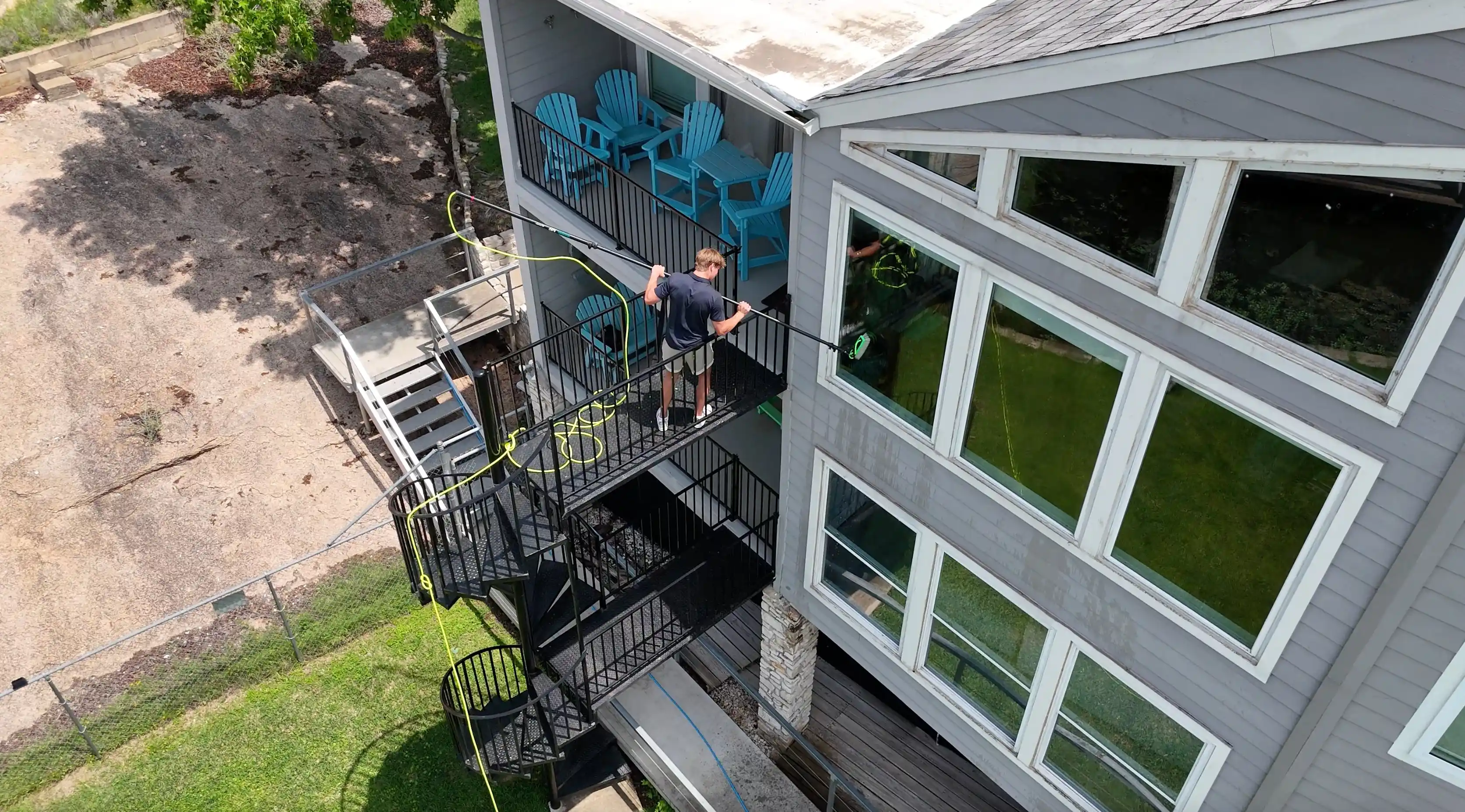 Aerial view of ClearCrew cleaning windows on a balcony in Central Texas